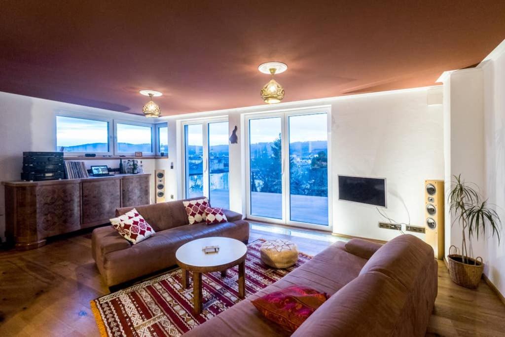 a living room with two couches and a table at Wohlfühloase mit Blick auf Trier in Trier