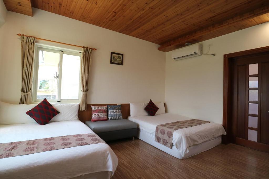 a hotel room with two beds and a window at Countryside B&amp;B in Ruisui