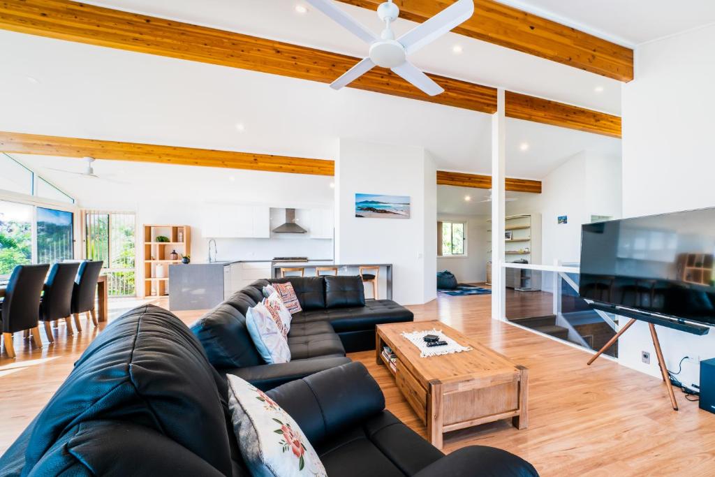 un salon avec un canapé et une table dans l'établissement Beachfront Escape, à Forster