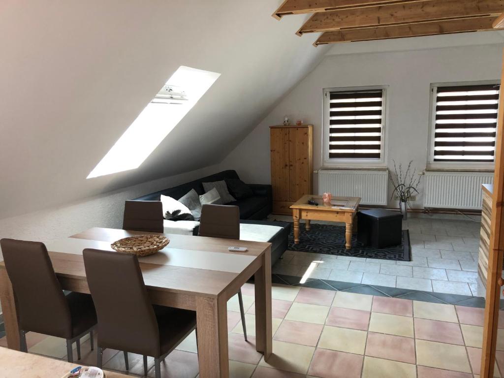 a living room with a table and a couch at Ferienwohnung mit Blick auf die Burg Stargard in Burg Stargard