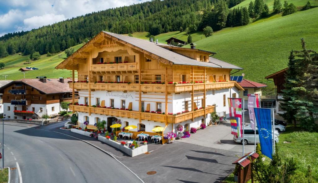 a large wooden building on the side of a road at Dolomitenhof in Kartitsch