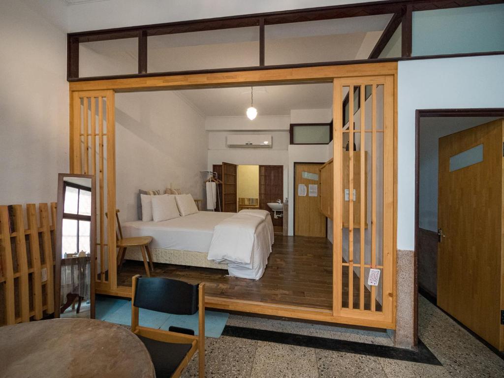 a bedroom with a bed and a large sliding glass door at 想起天井老宅民宿Thinking Homestay in Tainan