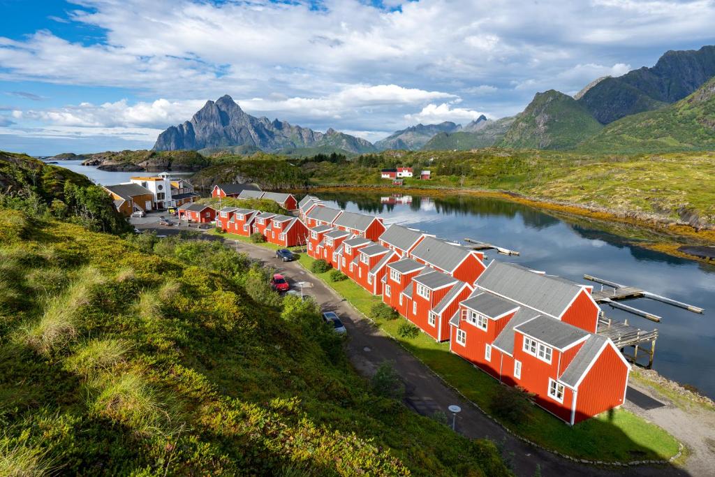 an aerial view of a row of houses on a river at Nyvågar Rorbuhotell - by Classic Norway Hotels in Kabelvåg