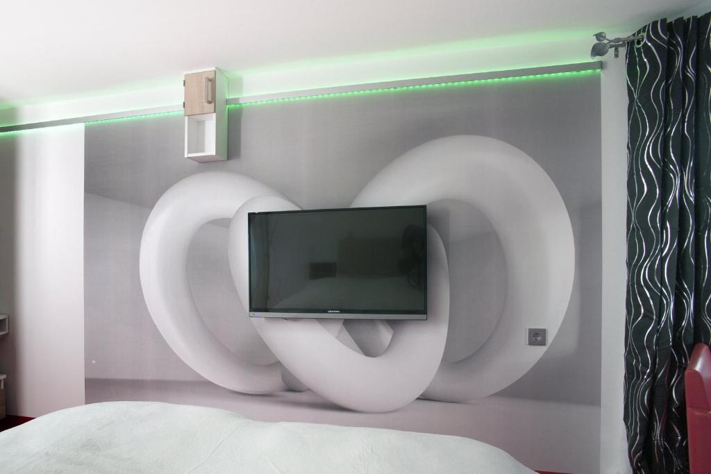 TV a/nebo společenská místnost v ubytování Boutique-Hotel UPGRADE