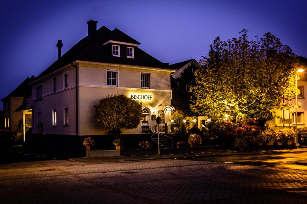 a building with a sign on the side of it at night at Gasthaus & Hotel Bischoff in Rodgau