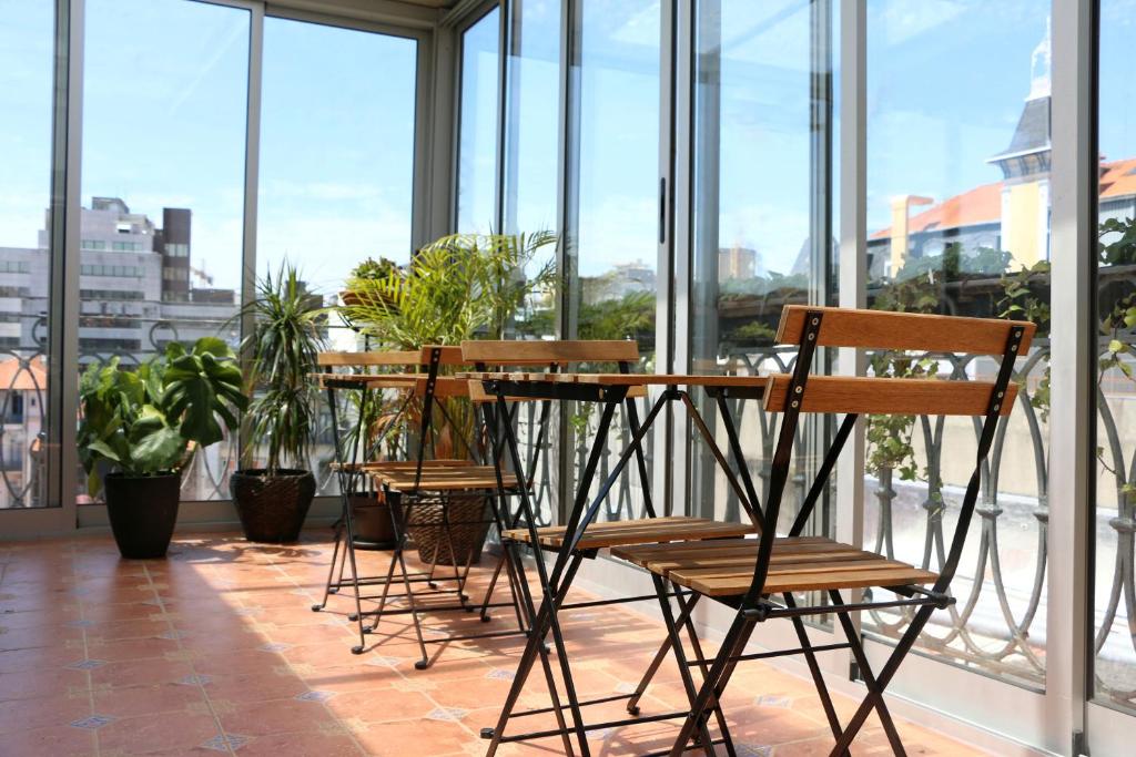 a dining area with chairs, tables and chairs at Santa Catarina Guest House (Porto city center) in Porto