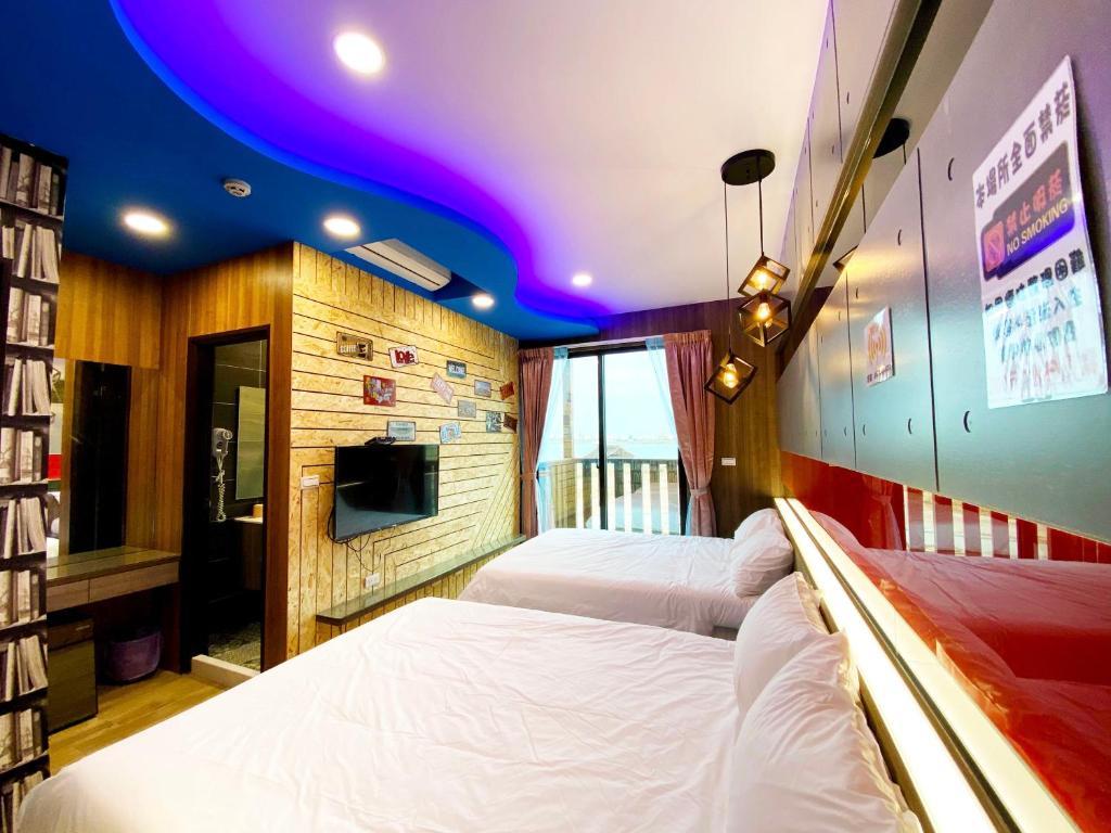 Postel nebo postele na pokoji v ubytování 奧斯卡海景民宿Oscar Boutique Seaview Homestay