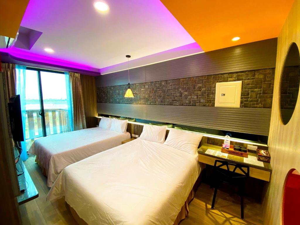 Postel nebo postele na pokoji v ubytování 奧斯卡海景民宿Oscar Boutique Seaview Homestay