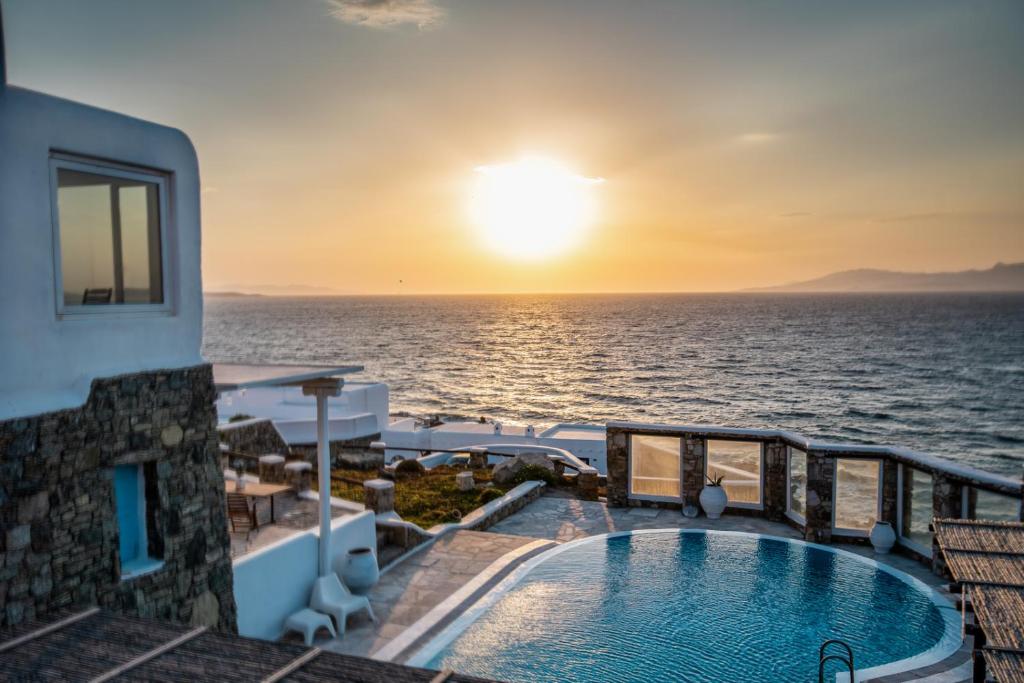 a view of the ocean from the balcony of a hotel at Sunset Villa Iza in Agios Ioannis Mykonos