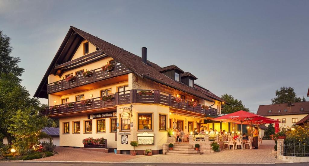 un edificio con mesas y sillas delante de él en Hotel Schloßberg en Gräfenberg