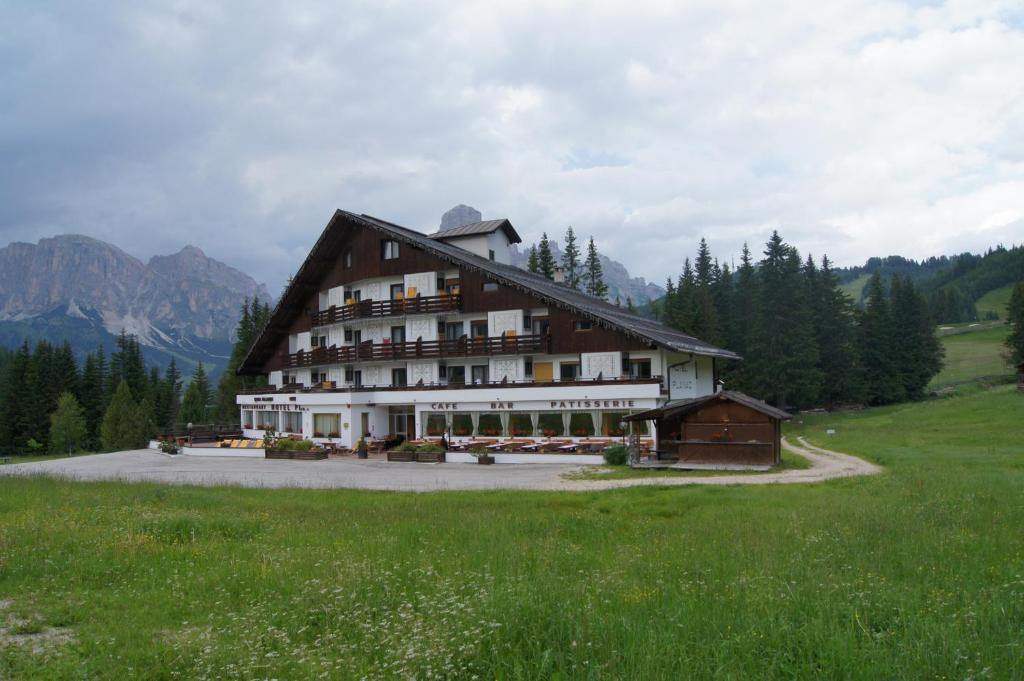 a large building in the middle of a field at Hotel Planac in Corvara in Badia