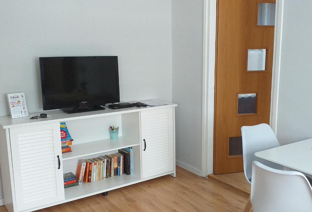 un armario blanco con un televisor encima. en Mieszkanie u Dominiki INPIW01, en Piwniczna-Zdrój