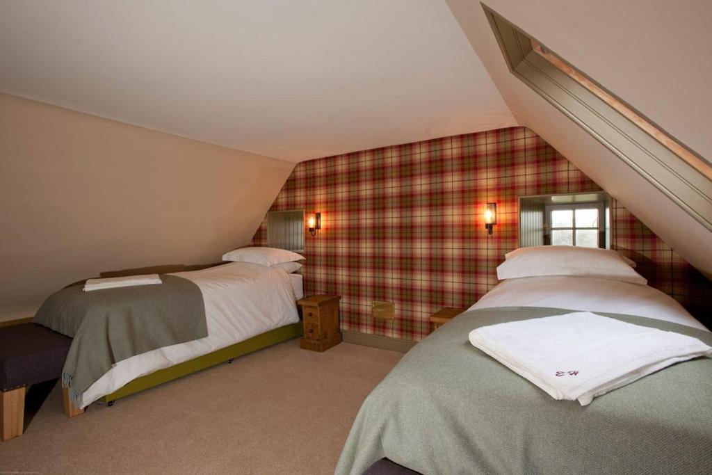 a bedroom with two beds in a attic at Balnakeil House in Balnakeil