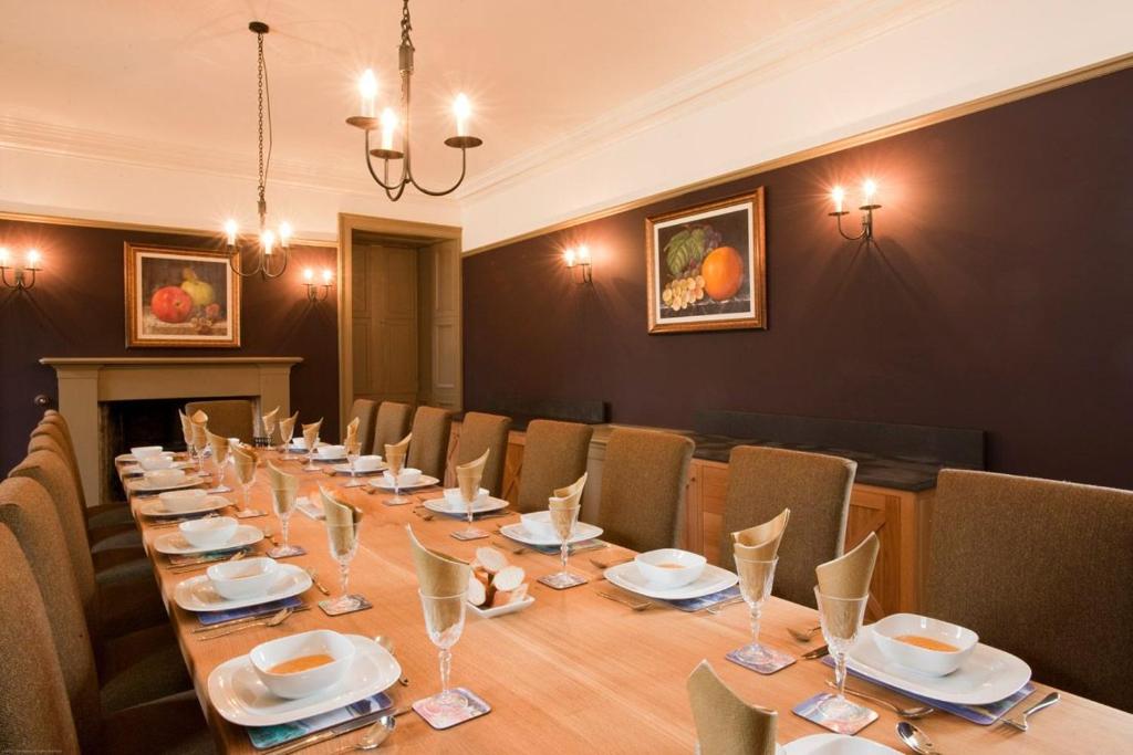 a conference room with a long table and chairs at Balnakeil House in Balnakeil