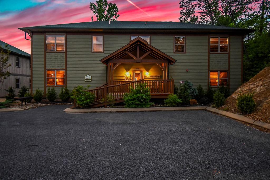 a house with a large porch with a deck at SmokyStays 10 Bedroom Cabin in Pigeon Forge