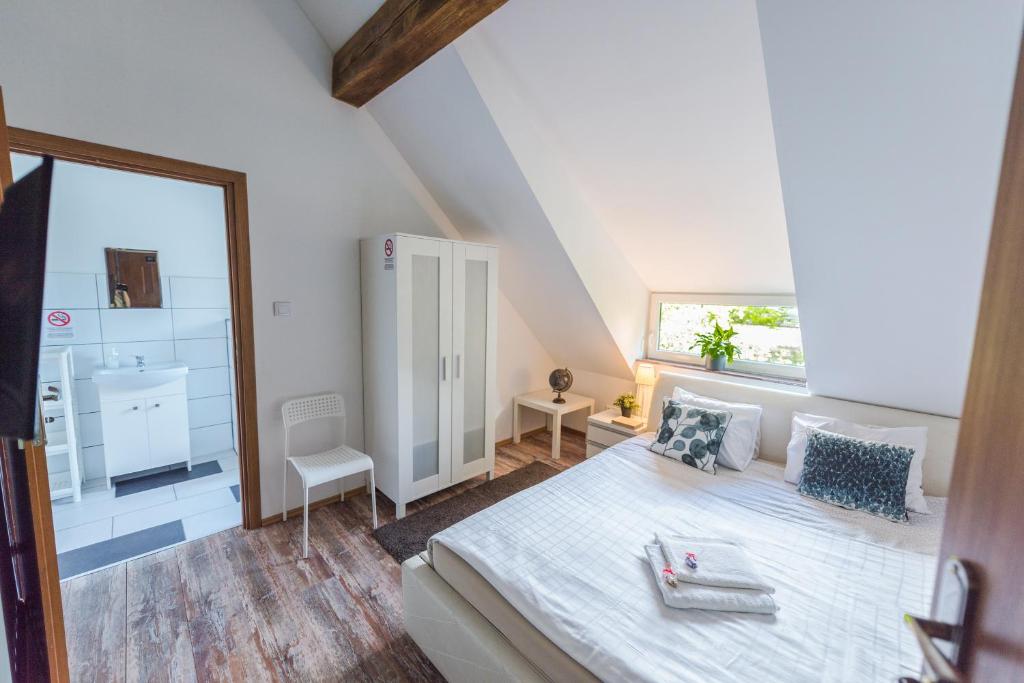 a bedroom with a large bed and a bathroom at Fitness Hostel Premium in Wrocław