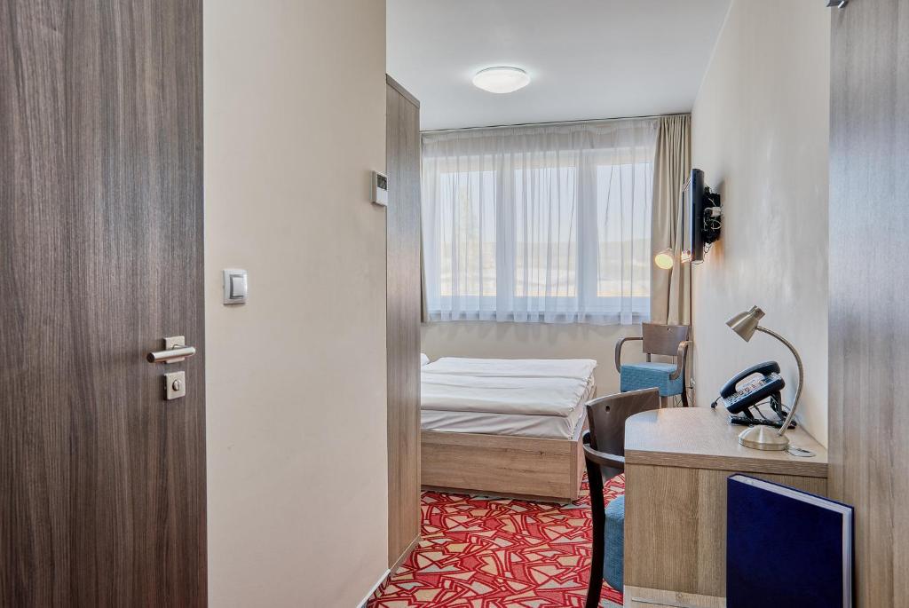 Postel nebo postele na pokoji v ubytování Hotel Arena