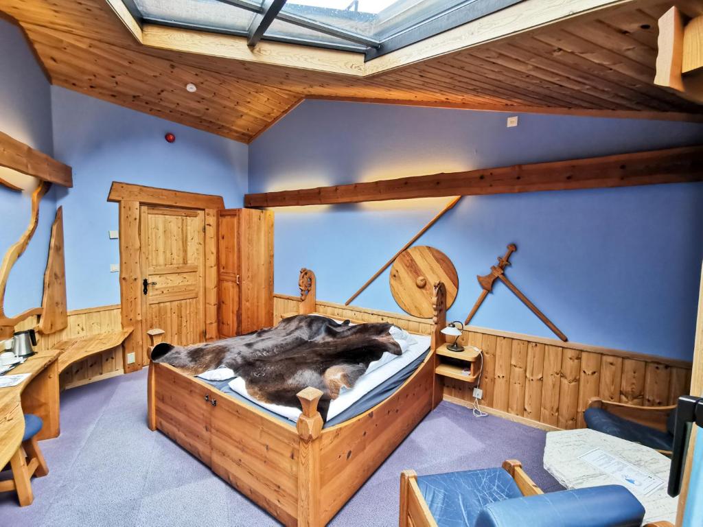 a bedroom with a large wooden bed in a room at Gudvangen Fjordtell in Gudvangen