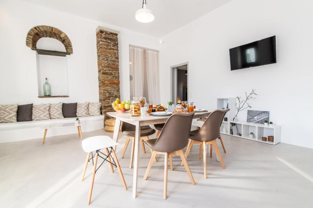 a kitchen and dining room with a table and chairs at Livadi house Tinos in Káto Klísma