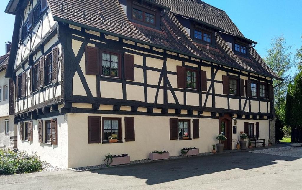 a half timbered building with windows and a roof at FeWo im Mesnerhaus Mengen in Mengen