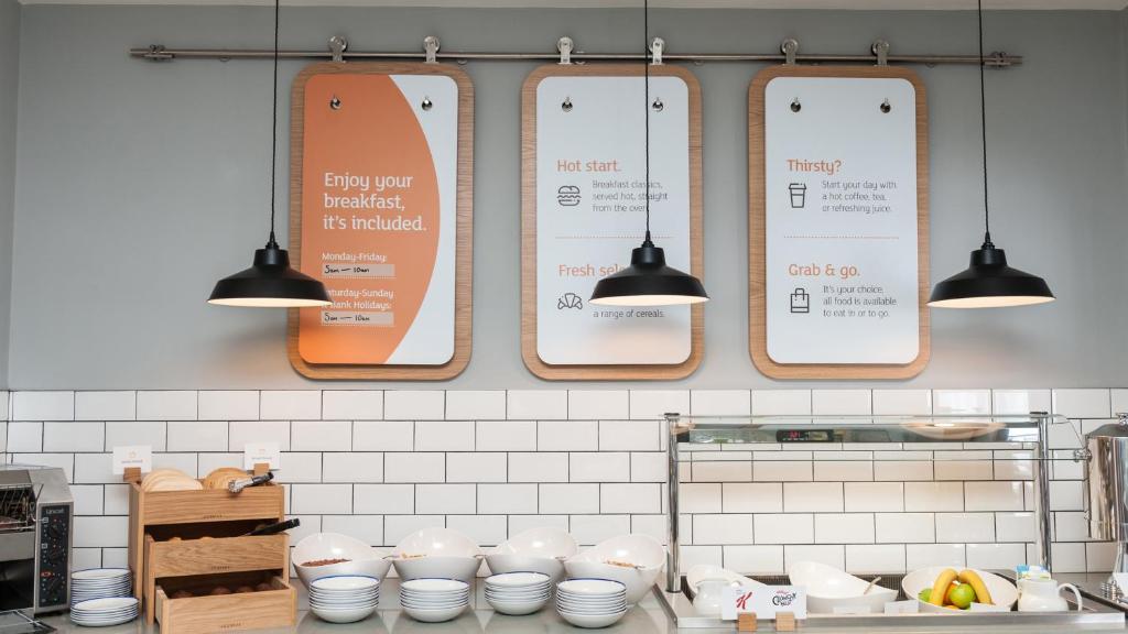 a kitchen with several signs hanging on the wall at Holiday Inn Express Aberdeen Airport by IHG in Dyce