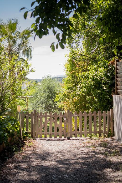 a wooden fence in a yard with trees at Villa Angel in La Gaude