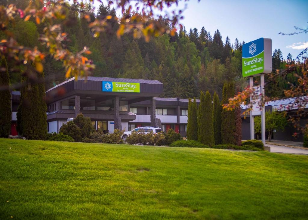 a building with a sign in the middle of a park at SureStay Hotel by Best Western Castlegar in Castlegar