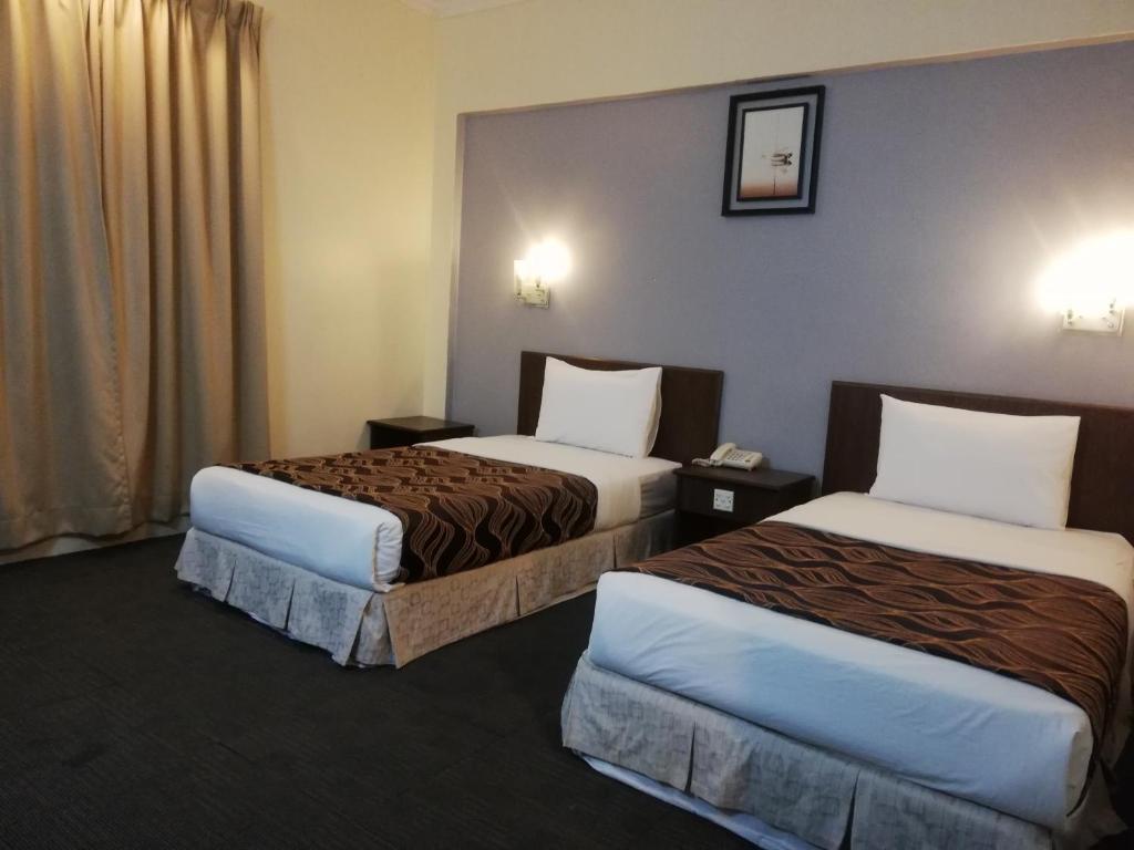 Postel nebo postele na pokoji v ubytování Hotel Damai