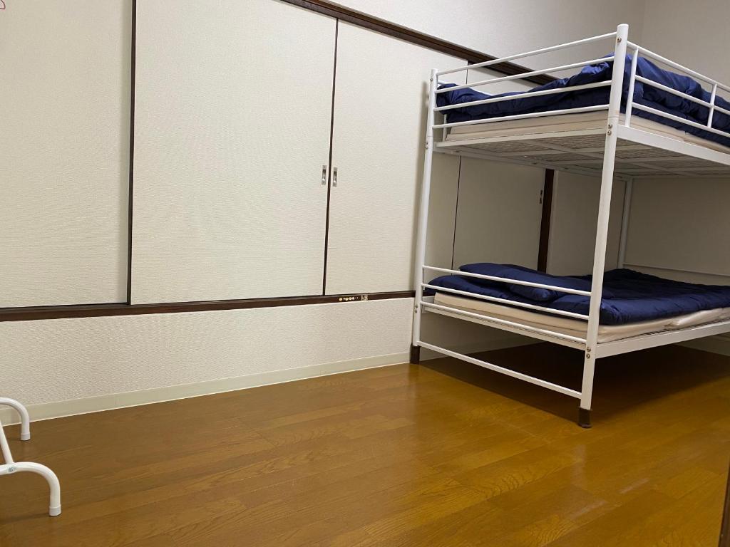 Postel nebo postele na pokoji v ubytování Akitaya Annex