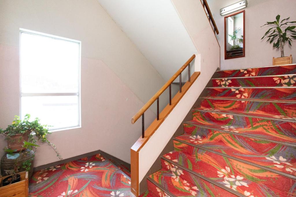 Postel nebo postele na pokoji v ubytování Tabist Hana Hotel Takinoya Aizu-Yanaizu