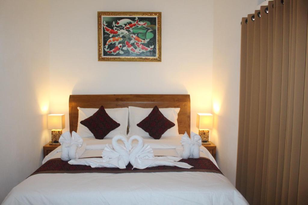 Postel nebo postele na pokoji v ubytování Intan Guest House