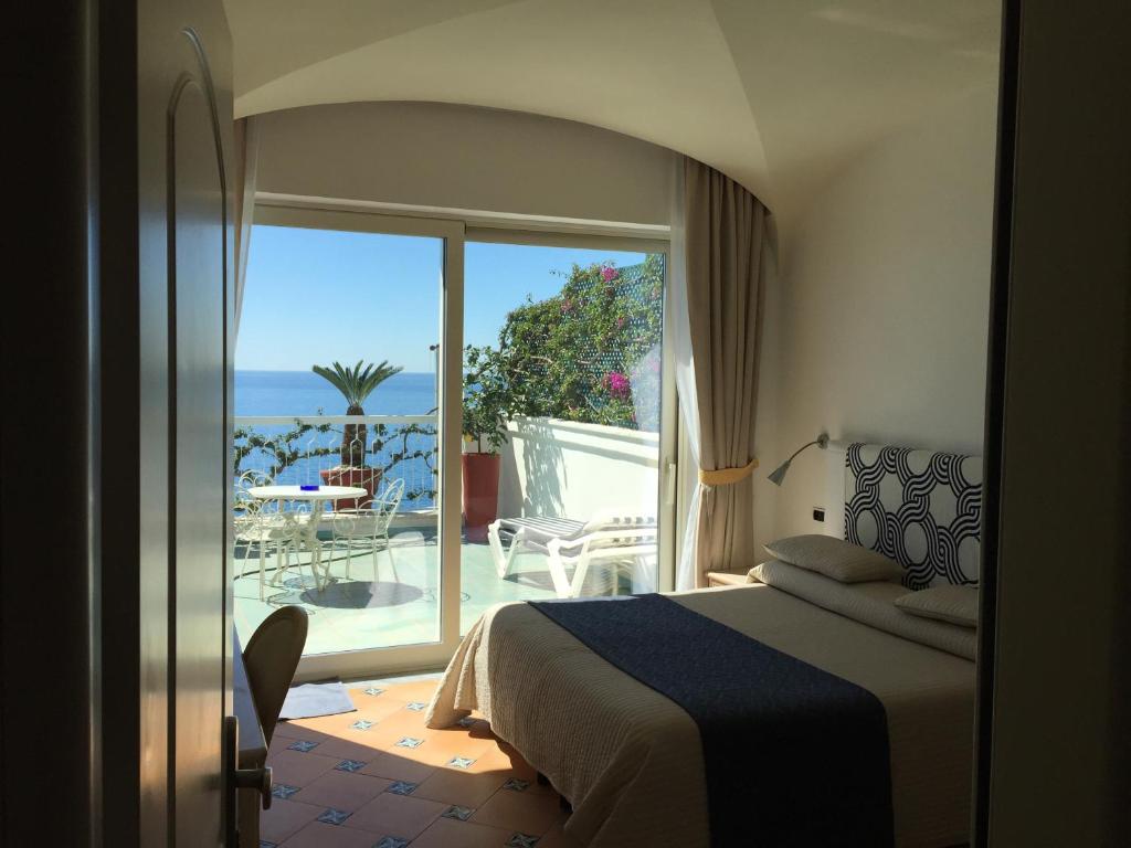a bedroom with a bed and a window at Hotel Bellevue Suite in Amalfi