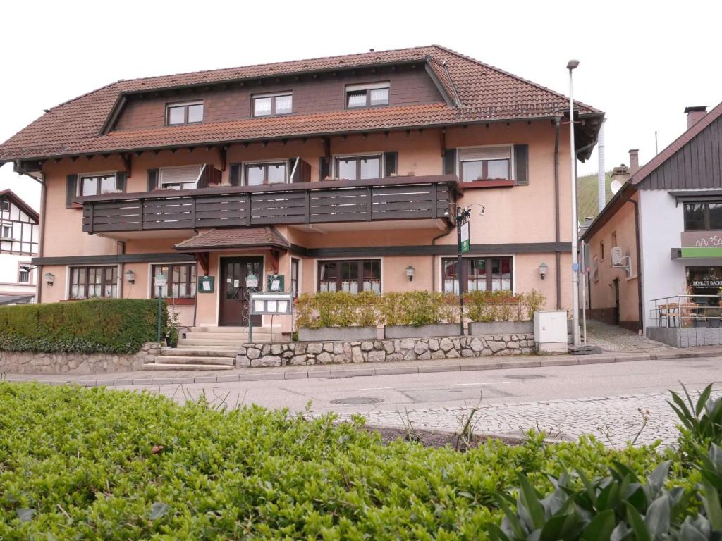 a large house with a balcony on a street at Gasthaus Engel in Bühlertal