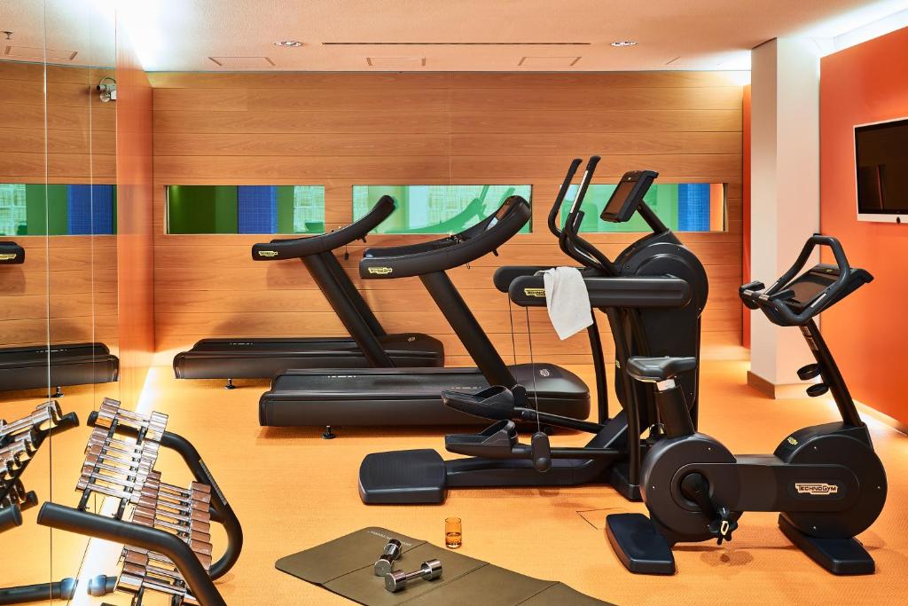 a gym with several exercise bikes in a room at SIDE, Hamburg, a Member of Design Hotels in Hamburg