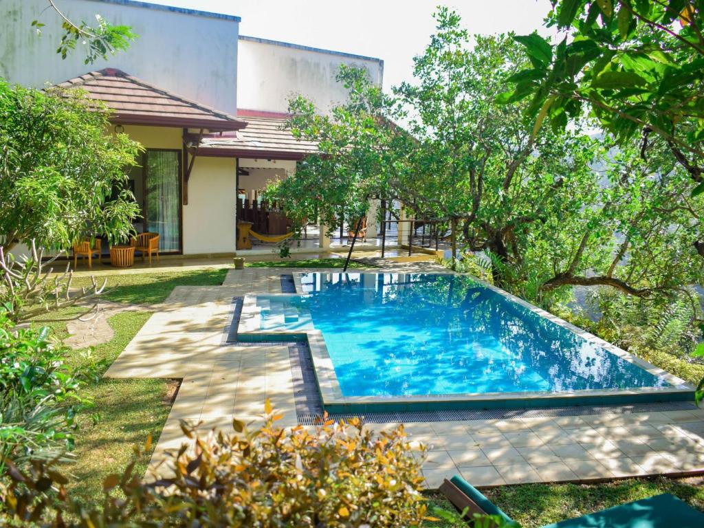 a swimming pool in the yard of a house at Aqua Dunhinda Villa in Kandy