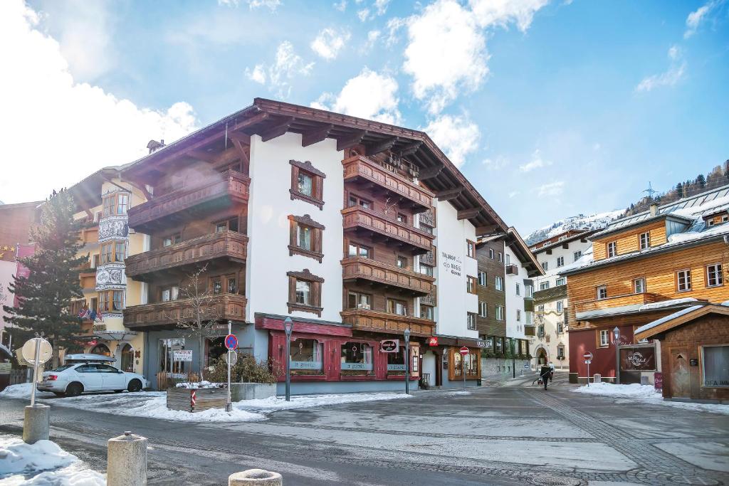 a building on the side of a street at Heart Hotel Talhof Nigg in Sankt Anton am Arlberg