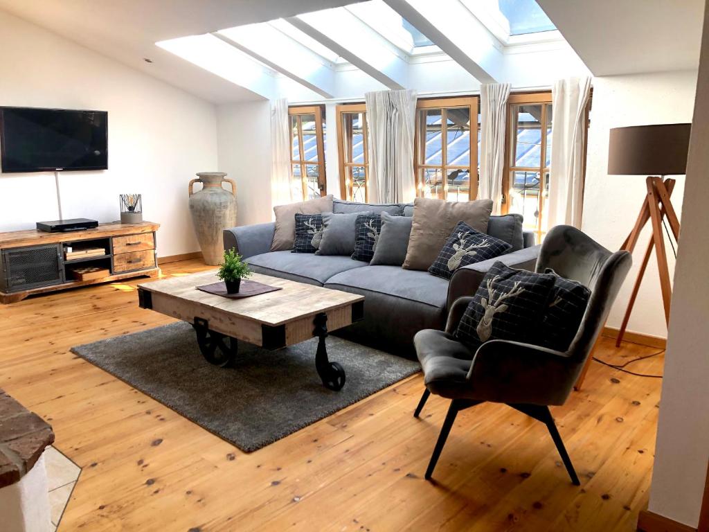 a living room with a couch and a table at BELLE KITZ im Zentrum by Belle Stay in Kitzbühel