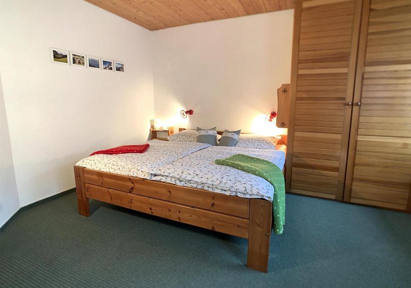 a bedroom with a wooden bed in a room at Haus Claudia Lipp in Bad Hindelang