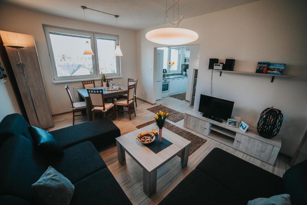 a living room with a couch and a table at Apartmán Tatranská Lomnica in Tatranská Lomnica
