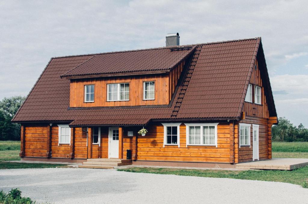 a wooden house with a brown roof at Rosi Puhkemaja in Koljala