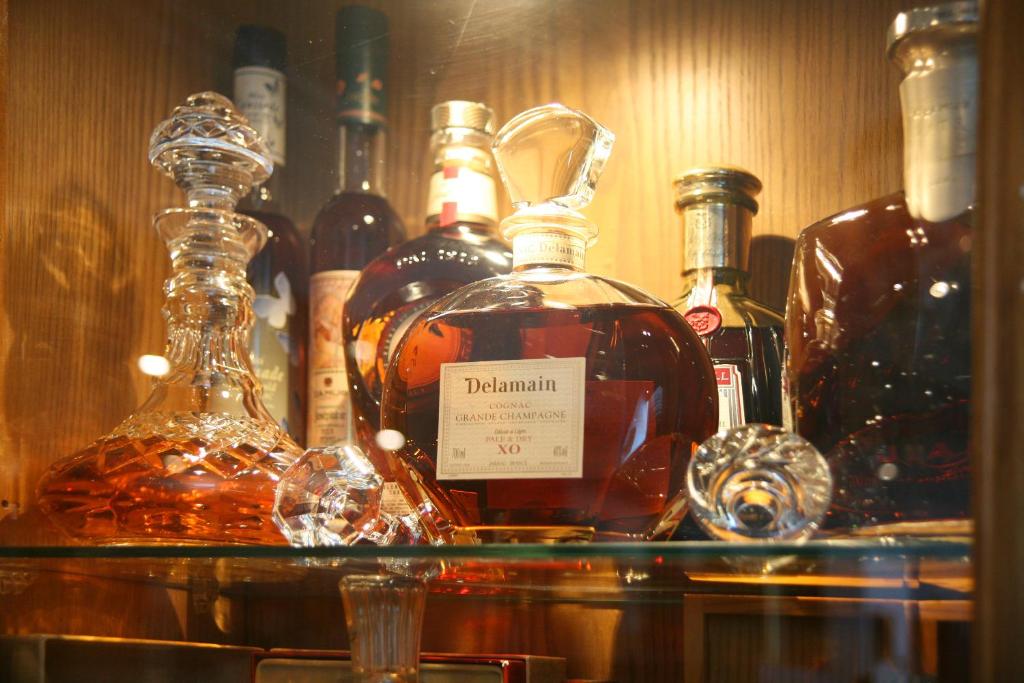a bunch of bottles of alcohol on a shelf at Chrielka Hotel in Limassol