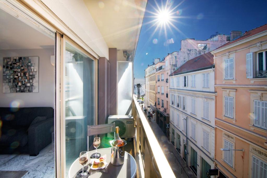 a balcony with a table and a view of a city at Near Croisette- 4 Star Studio -SeaView in Cannes