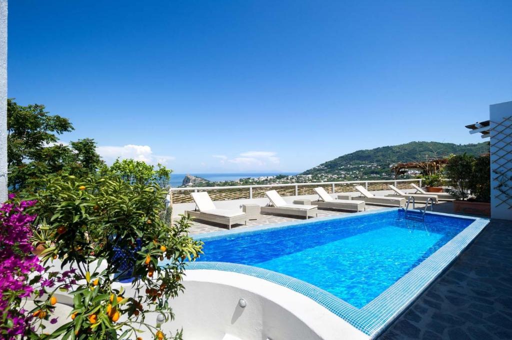 a large swimming pool with a balcony overlooking the ocean at Relais Bijoux Ischia in Ischia