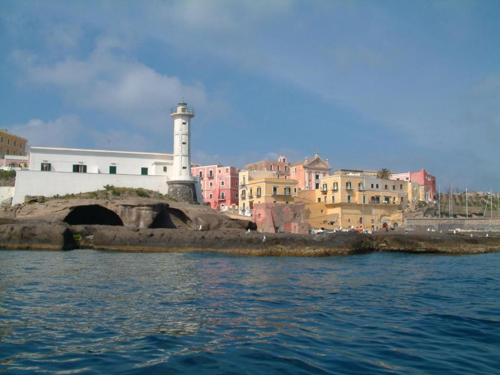 a lighthouse in a city with a body of water at Affittacamere Via Muraglione in Ventotene