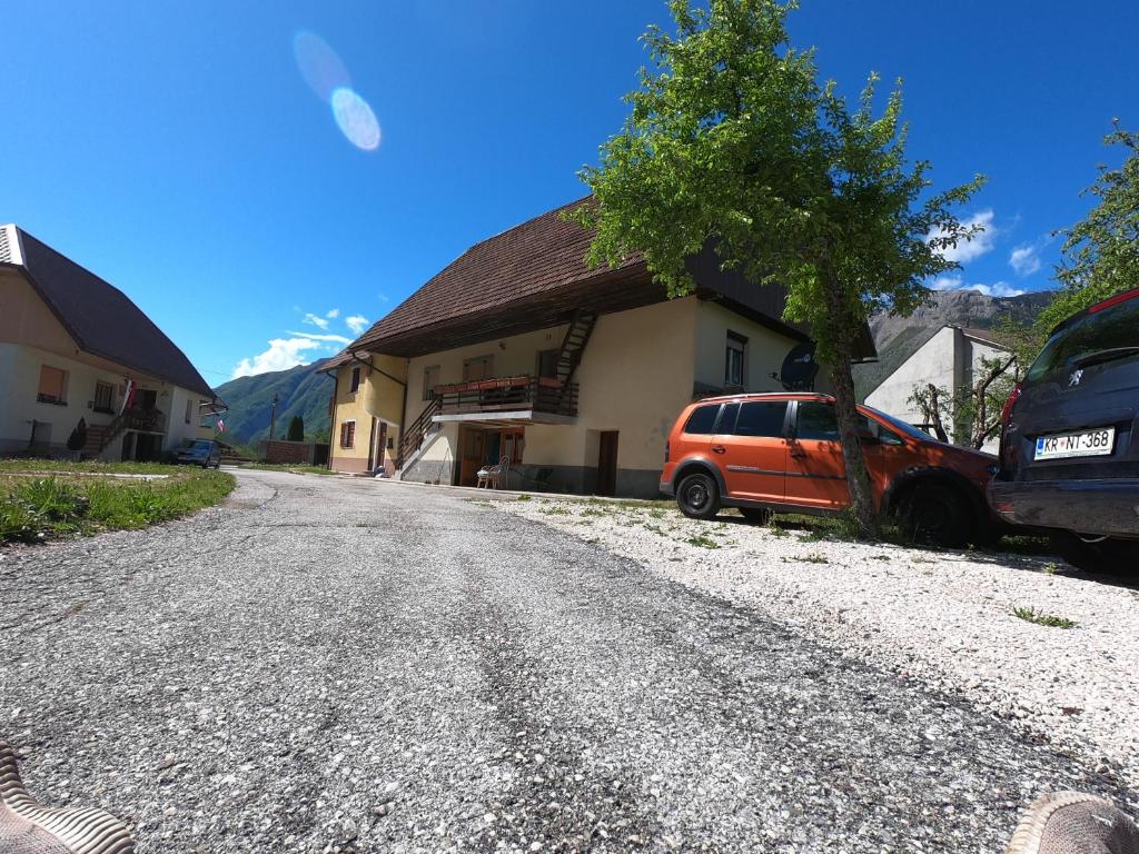a car parked next to a house on a gravel road at Holiday Home Over The River in Bovec