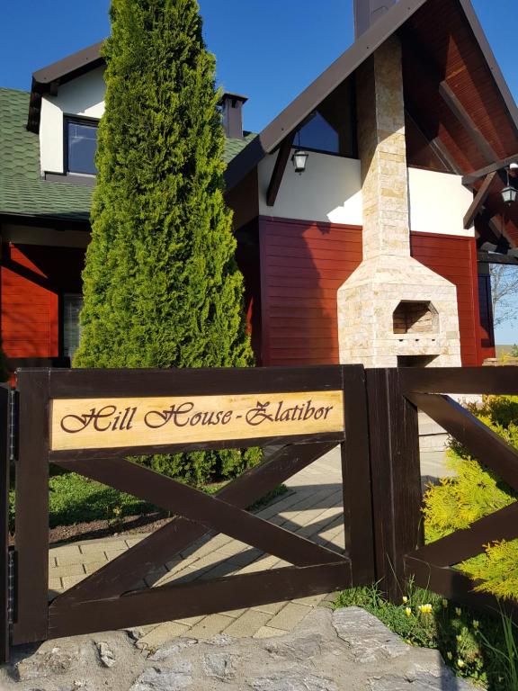 a sign in front of a house at Apartments Hill House Zlatibor in Zlatibor
