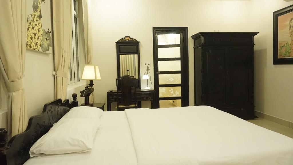 Postel nebo postele na pokoji v ubytování Hue Nino Hotel
