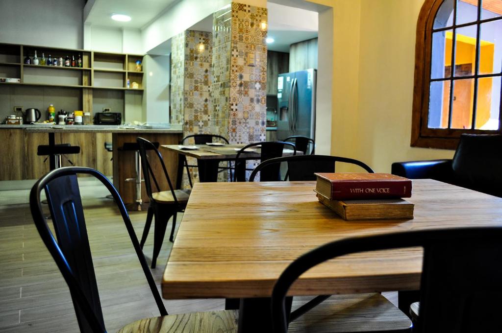 a wooden table with a book on top of it at The Fox Hostel in Santiago
