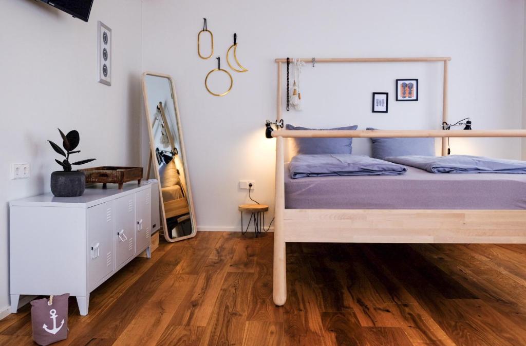 a bedroom with a bunk bed and a wooden floor at Hacienda Hotel in Friedrichshafen