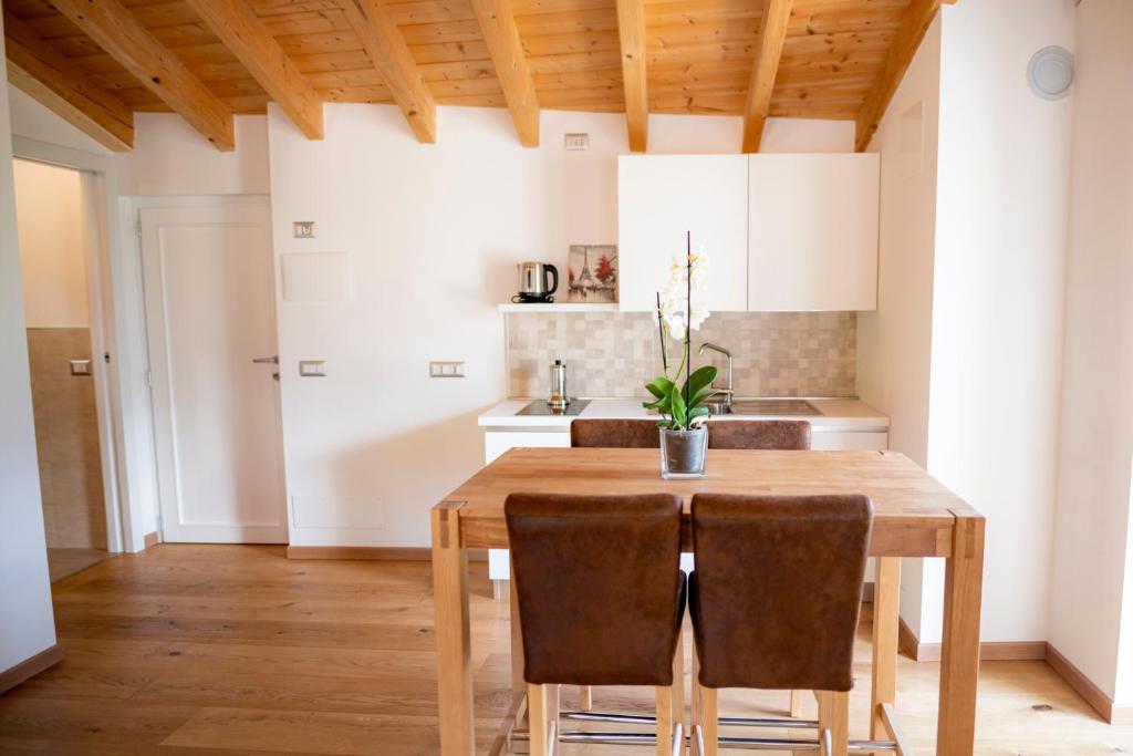 a kitchen with a wooden table and chairs at B&B Sopralapanca in Postalesio